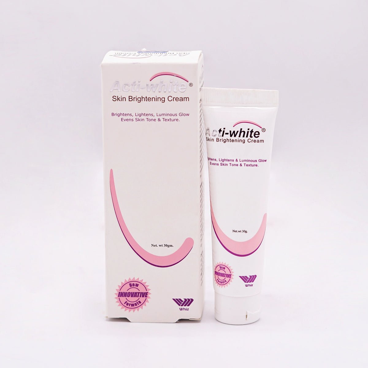 Acti-white Skin Brightening Cream, Net wt 30gm, in a white tube with a pink and white label and a matching white and pink box featuring a smiling mouth graphic, set on a white background.