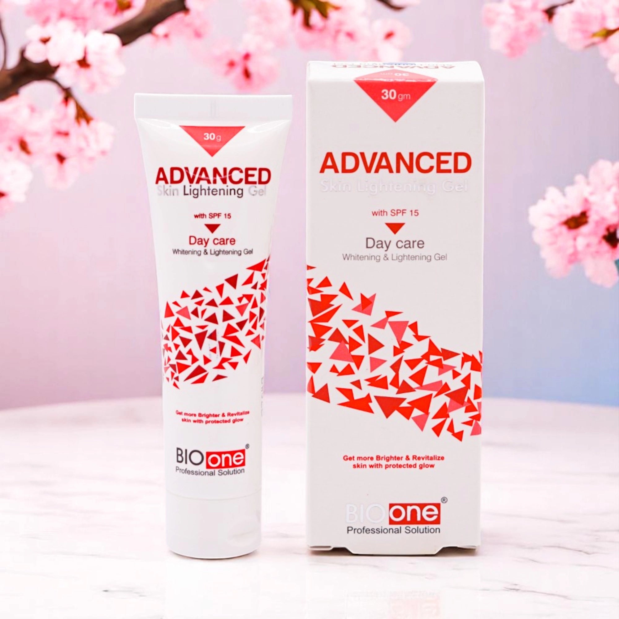 Bio One Advanced Skin Lightening Gel with SPF 15, 30g white tube with red and white accents, and its matching white and red box, set against a background of pink cherry blossoms.