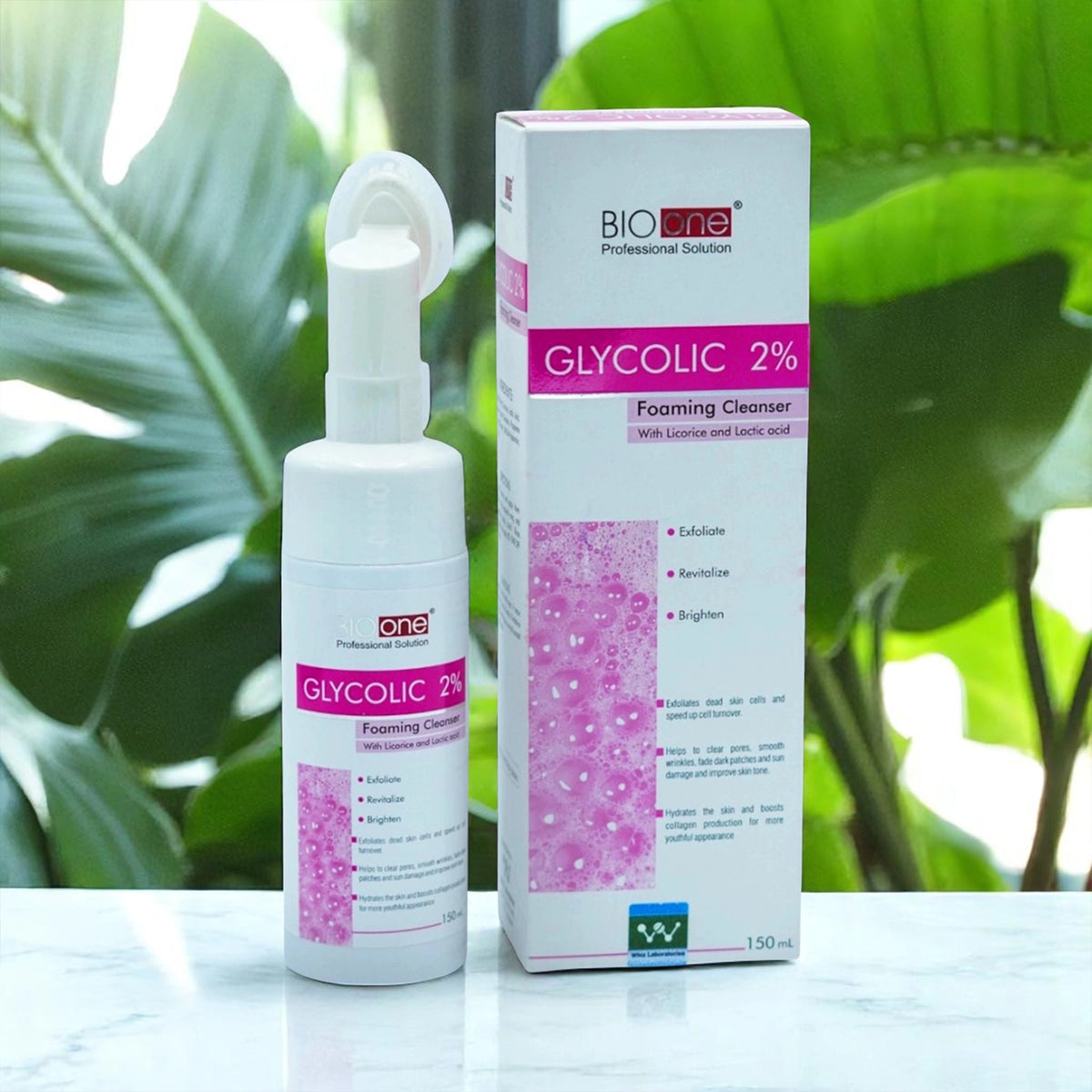 Bio One Glycolic 2% Foaming Cleanser, 150ml pump bottle and its pink and white box, with a leafy green background.