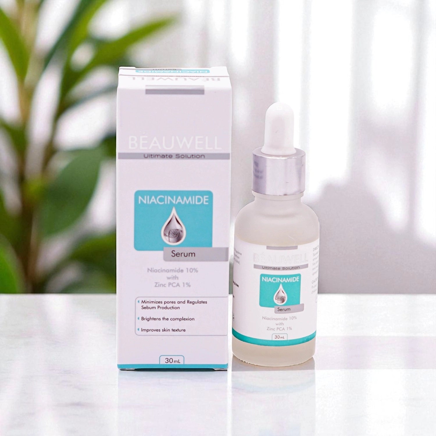 A bottle of Beauwell Niacinamide serum placed beside its packaging box on a neutral background.
