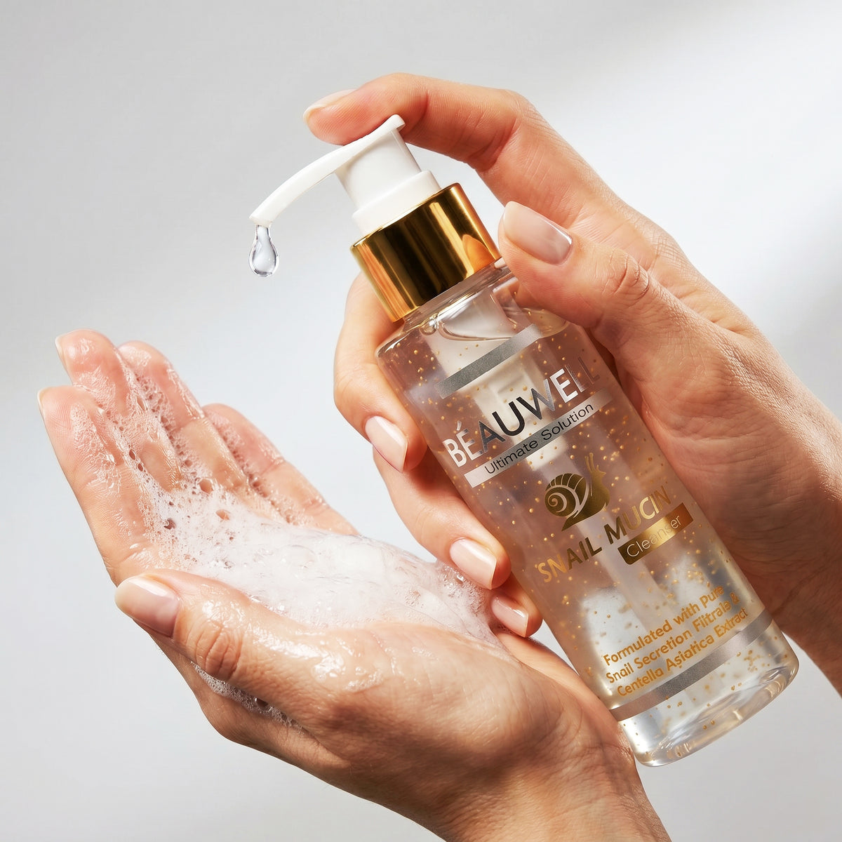 Beauwell Snail Mucin Cleanser being pumped into a hand with rich foaming lather.