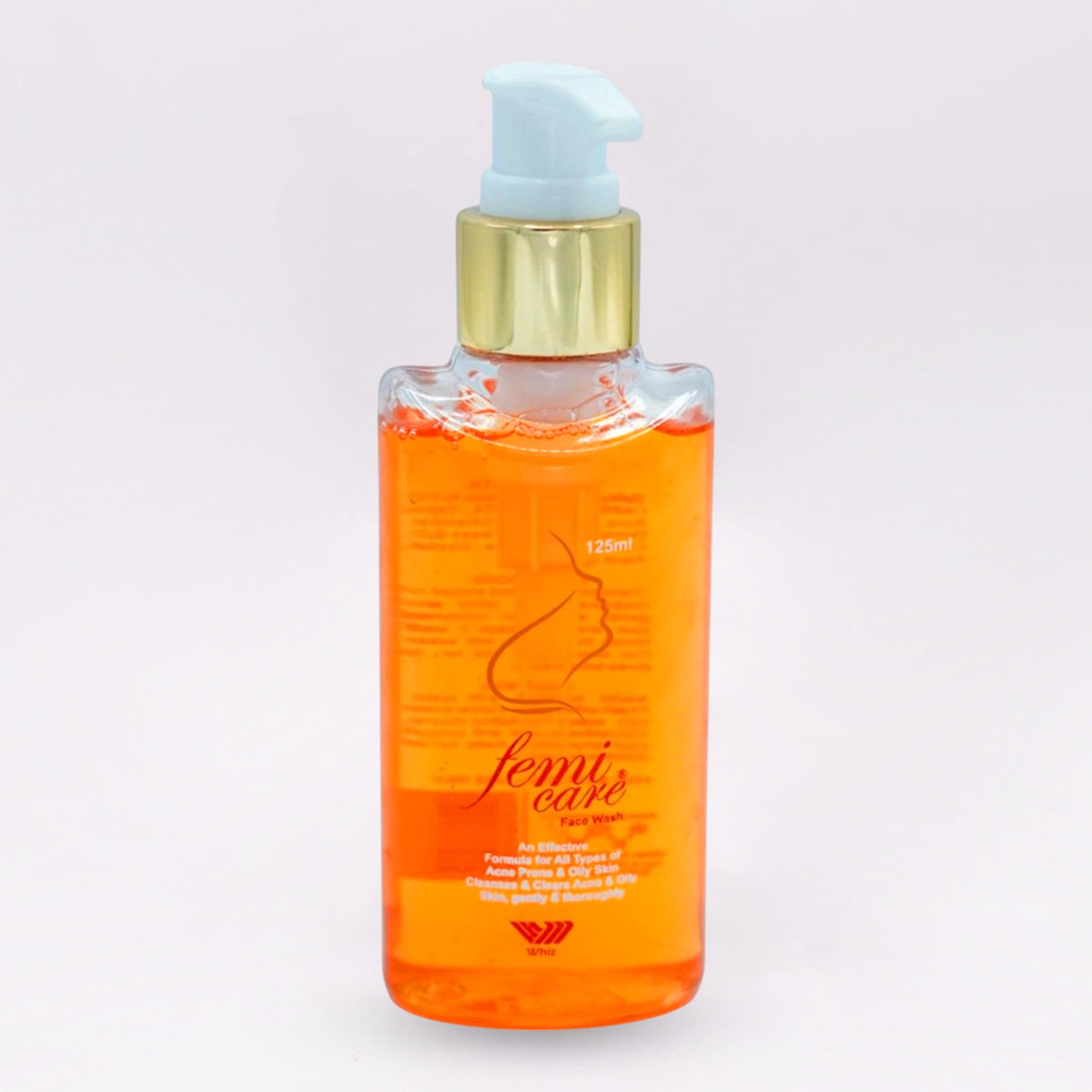 Femicare Face Wash, 125ml clear bottle with an orange liquid and a gold pump, featuring a feminine silhouette on the label.