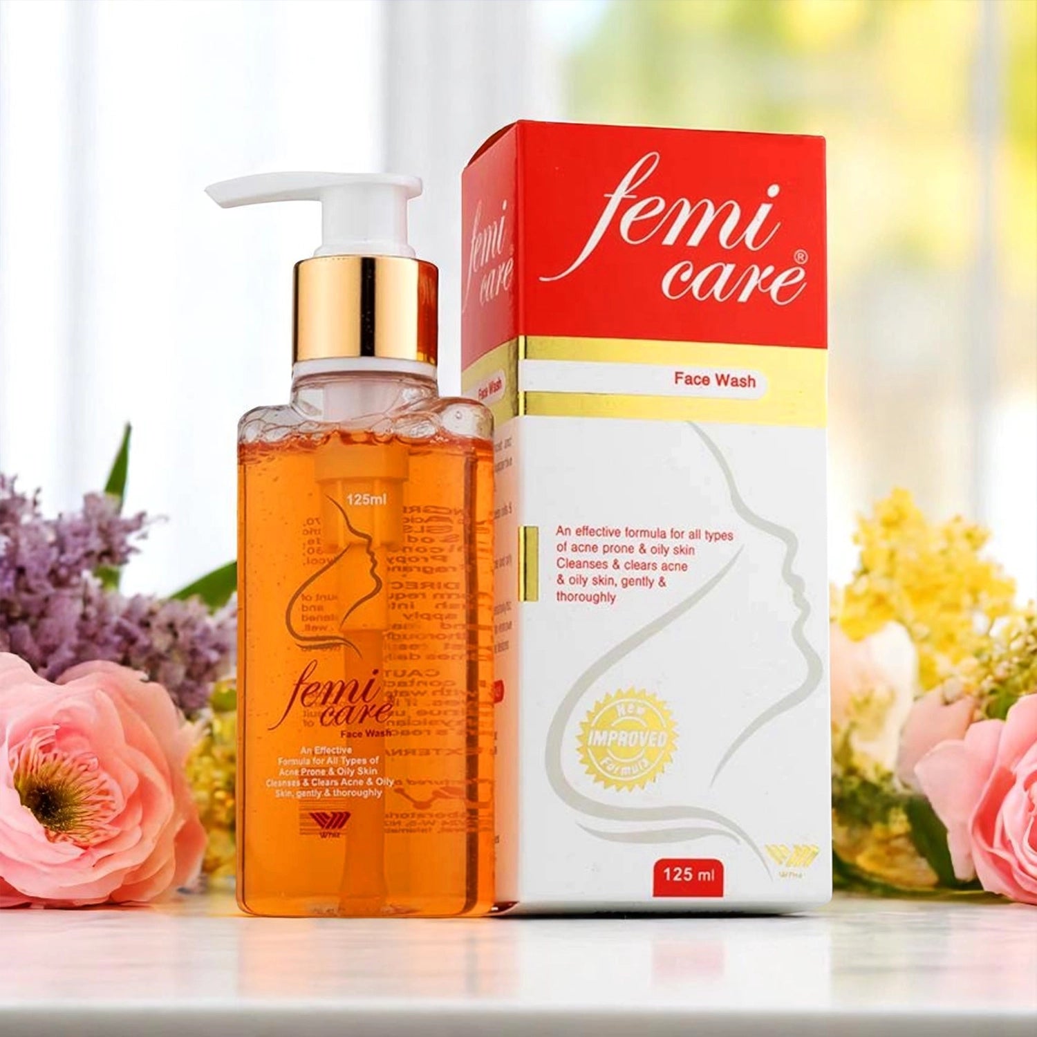 Femicare Face Wash, 125ml pump bottle with an orange liquid and a gold pump, alongside its red and white box.