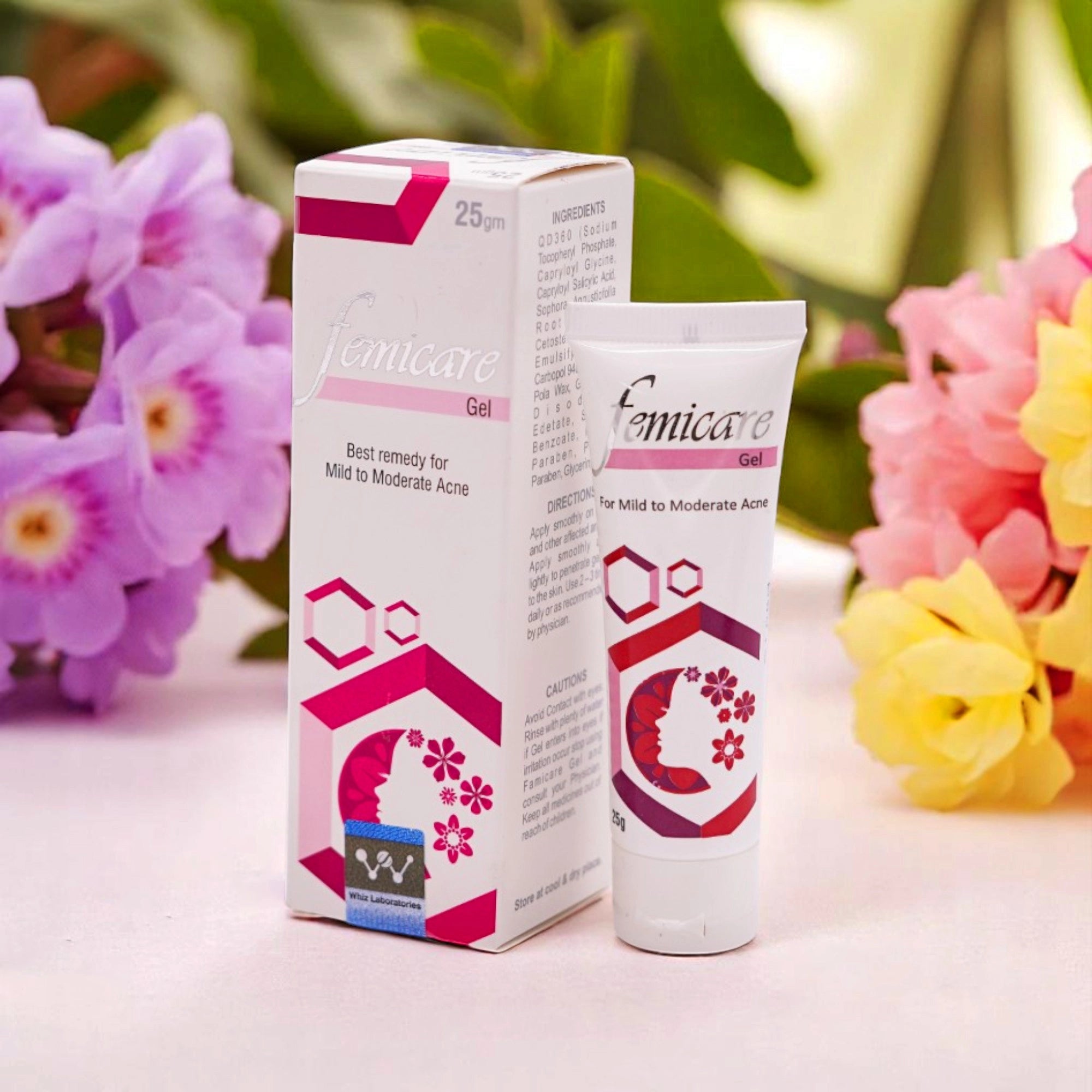 Femicare Acne Gel, 25gm white tube with pink and purple accents, and its matching white and pink box, set against a background of purple and yellow flowers.