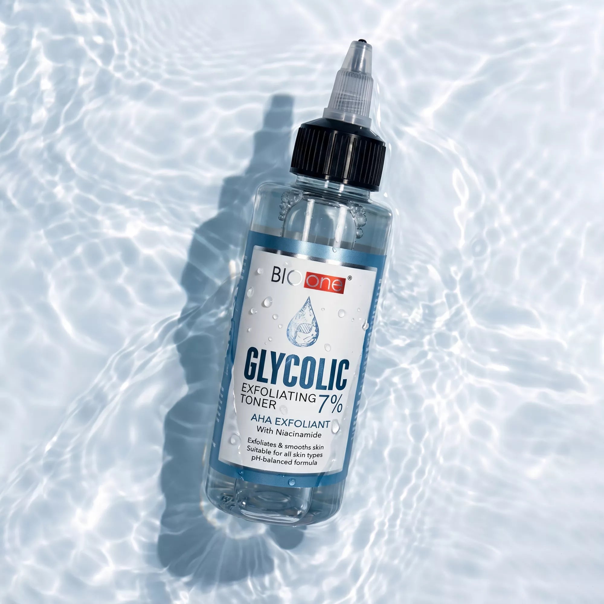 BIO ONE Glycolic 7% Exfoliating Toner bottle in rippled water.