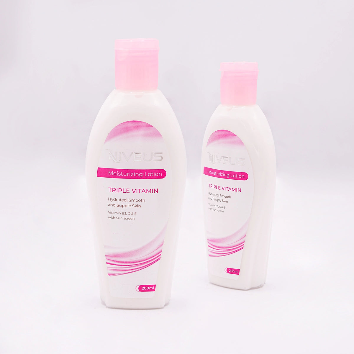 Two Niveus Moisturizing Lotion bottles, Triple Vitamin, for Hydrated, Smooth and Supple Skin, with Vitamins and Sun Screen, 200ml, in white bottles with pink caps and pink and white labels.
