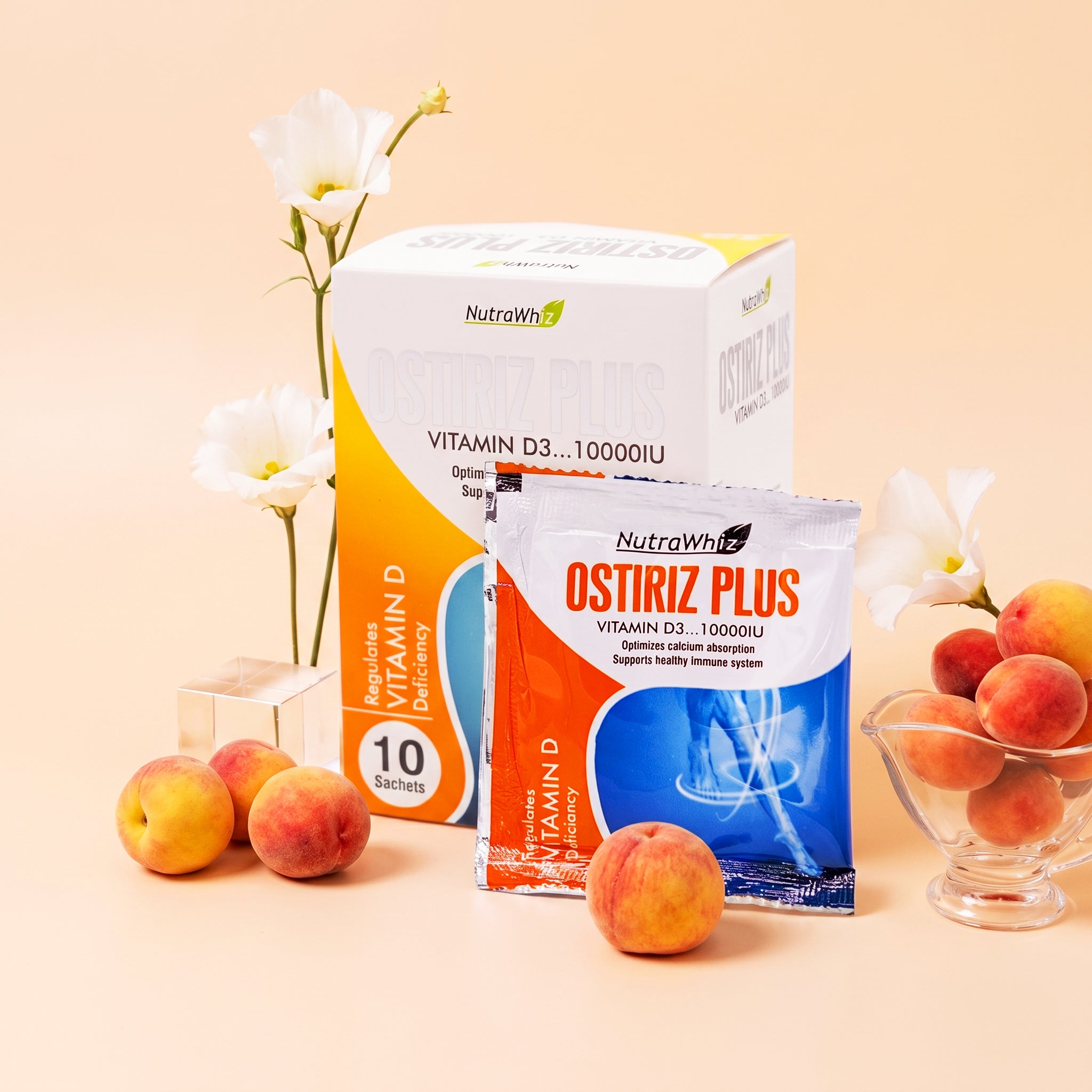 Ostiriz Plus Vitamin D3 10000IU sachet and box displayed with fresh peaches and white flowers