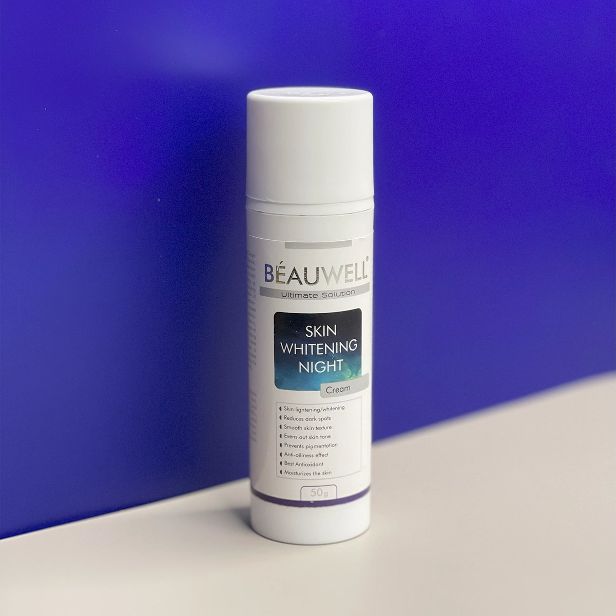 A photo of a Beauwell Skin Whitening Night Cream bottle with a pump dispenser. The label indicates the product is for skin lightening and contains 50g