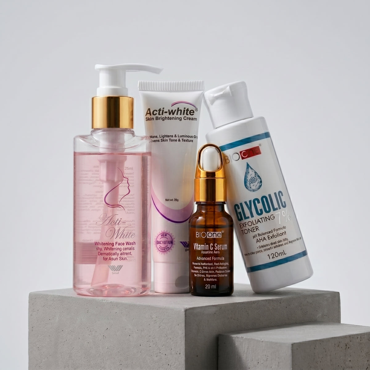Whiz Glow Therapy Kit featuring Acti-White Face Wash, Acti-White Cream, BIO ONE Vitamin C Serum, and BIO ONE Glycolic Exfoliating Toner on white pedestal blocks.