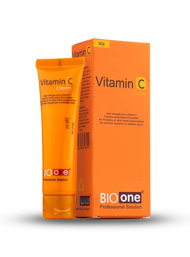 A bottle of cream next to a box